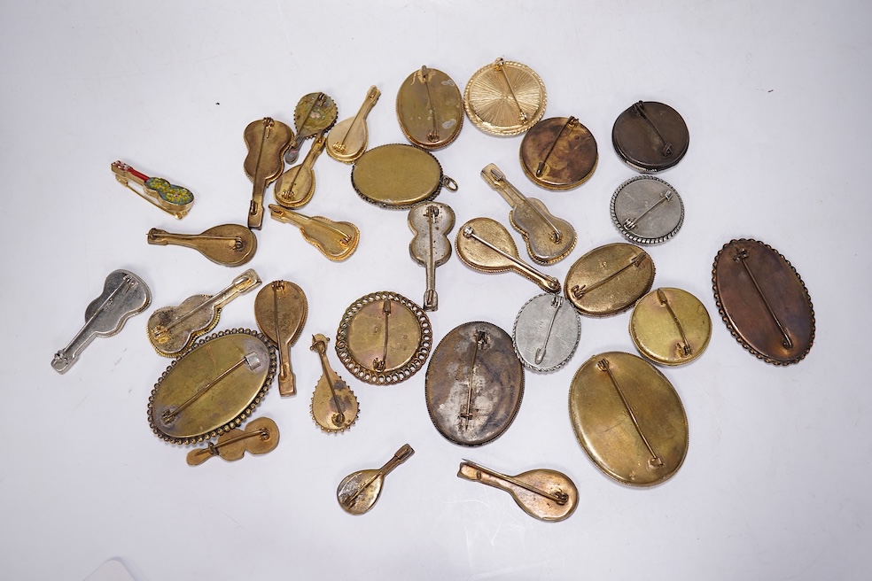 Thirty-one costume micro-mosaic brooches, to include seventeen guitar and banjo shaped brooches, five large oval/ circular brooches including scenic swan brooch, eight, smaller brooches and a pendant. Condition - fair/go